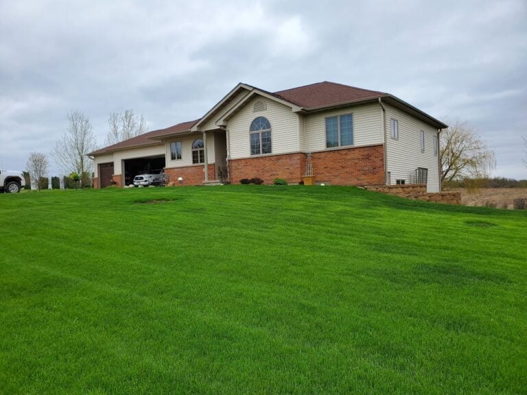 Lush green lawn installation for a well-manicured front yard. Professional sod installation enhances curb appeal and improves soil health for a vibrant, low-maintenance landscape.